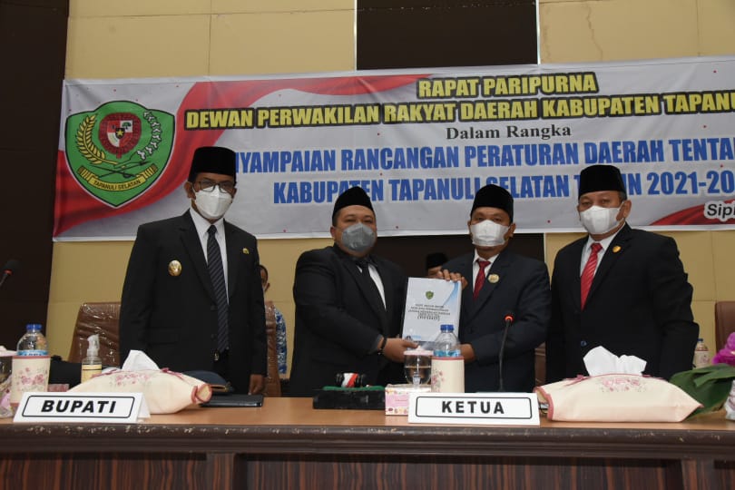 Bupati menyerahkan Ranperda tentang RPJMD Kabupaten Tapsel Tahun 2021-2026 kepada Ketua DPRD Tapsel Husin Sogot Simatupang pada sidang paripurna di Gedung DPRD Tapsel, Jalan Prof. Lafran Pane, Sipirok, Jumat (23/7). beritasore/Birong RT  