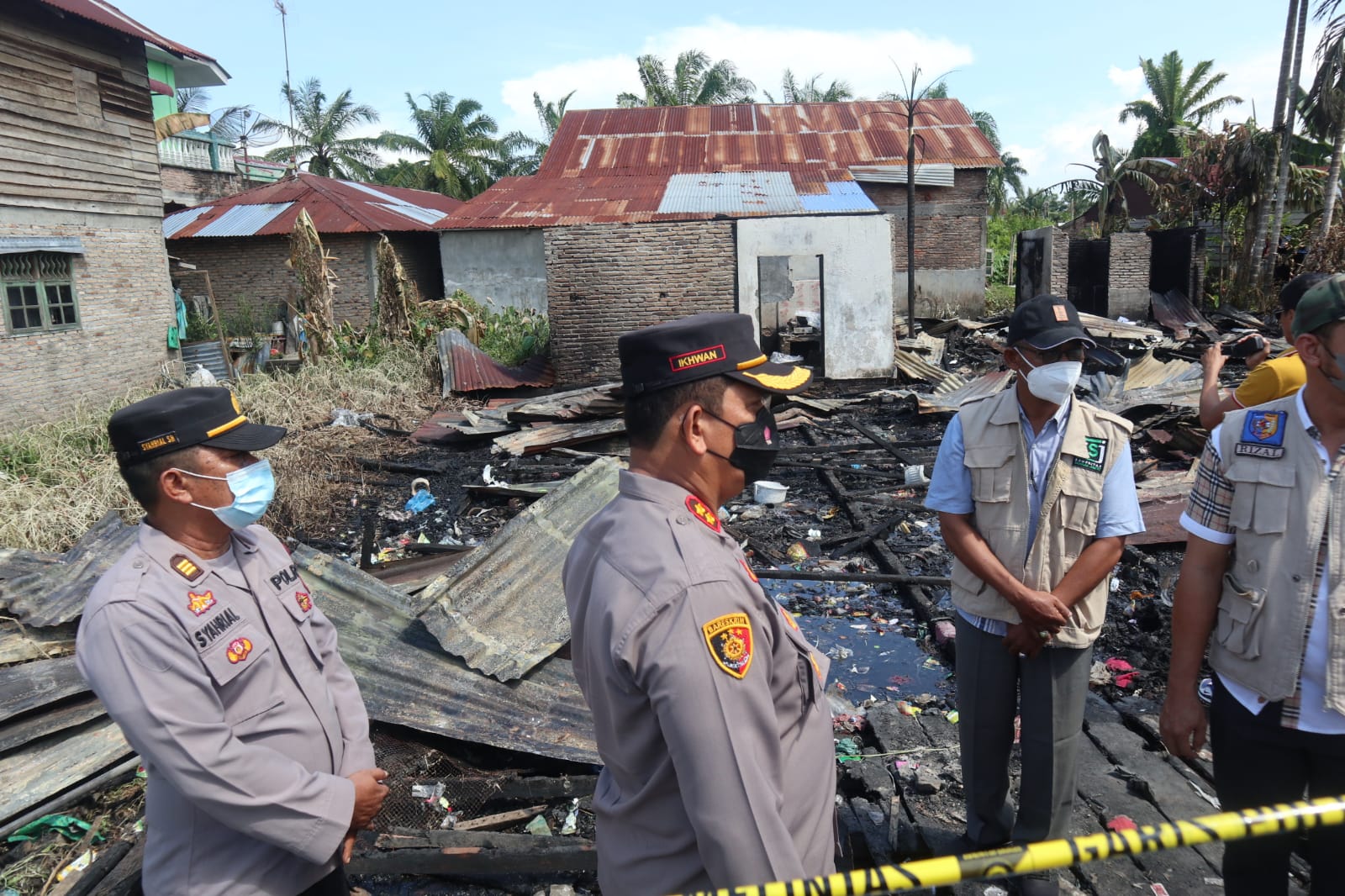 Kapolres Ke-6 Batubara AKBP H.Ikhwan Lubis SH,MH dan Ketua Komunitas Sedekah Jum'at (KSJ) Rizal Syahreza SE meninjau lokasi kediaman korban kebakaran Dusun II Gg. Saragih Desa Kampung Lalang Kec.Tanjung Tiram Kab.Batubara Sumatera Utara, Kamis (25/11/2021).beritasore/alirsyah