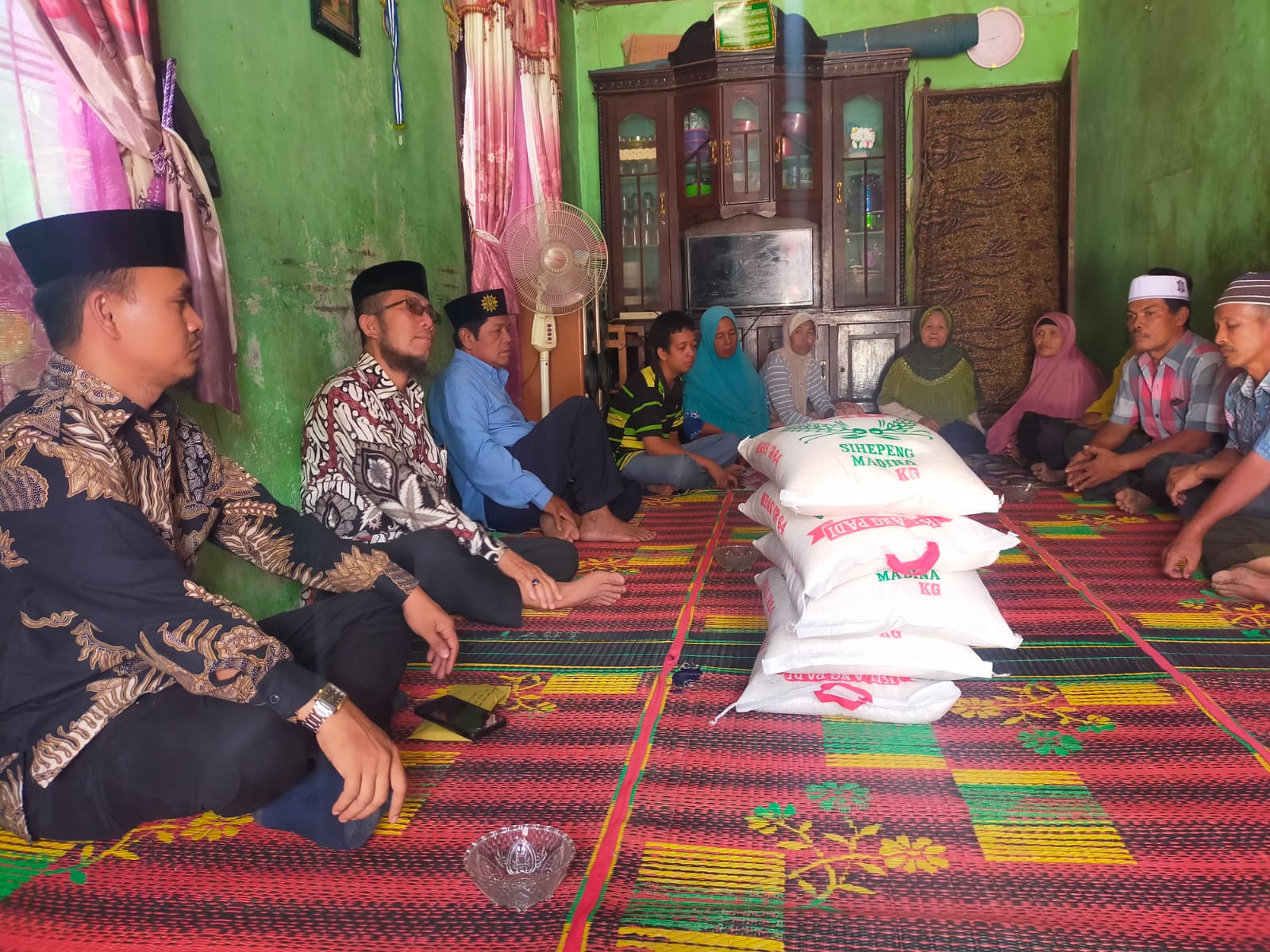 Teks foto Berita/ist Ketua Pimpinan Daerah Muhammadiyah Mandailing Natal Drs.M Yusuf Nasution, MSi didampingi pengurus lainnya menerahkan bantuan kepada korban kebakaran Sihepeng.