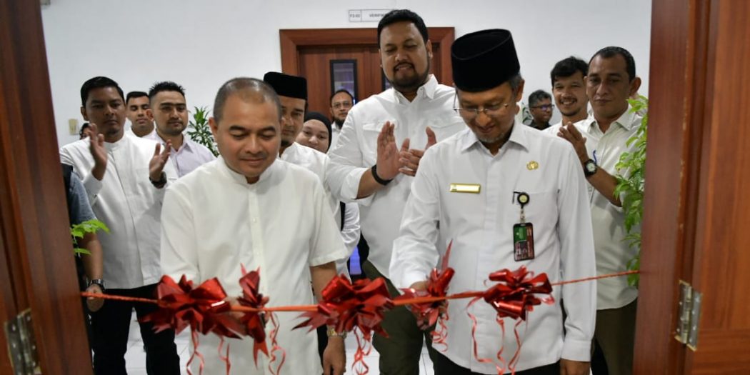 Asisten Administrasi Umum Sekda Aceh, H. Iskandar, AP, bersama Inspektur Aceh, Jamaluddin, melakukan pengguntingan pita saat meluncurkan Klinik e-katalog Lokal Aceh di Biro PBJ, Kantor Gubernur Aceh, Banda Aceh, Jumat, (1/9). (Foto: Zafrullah)