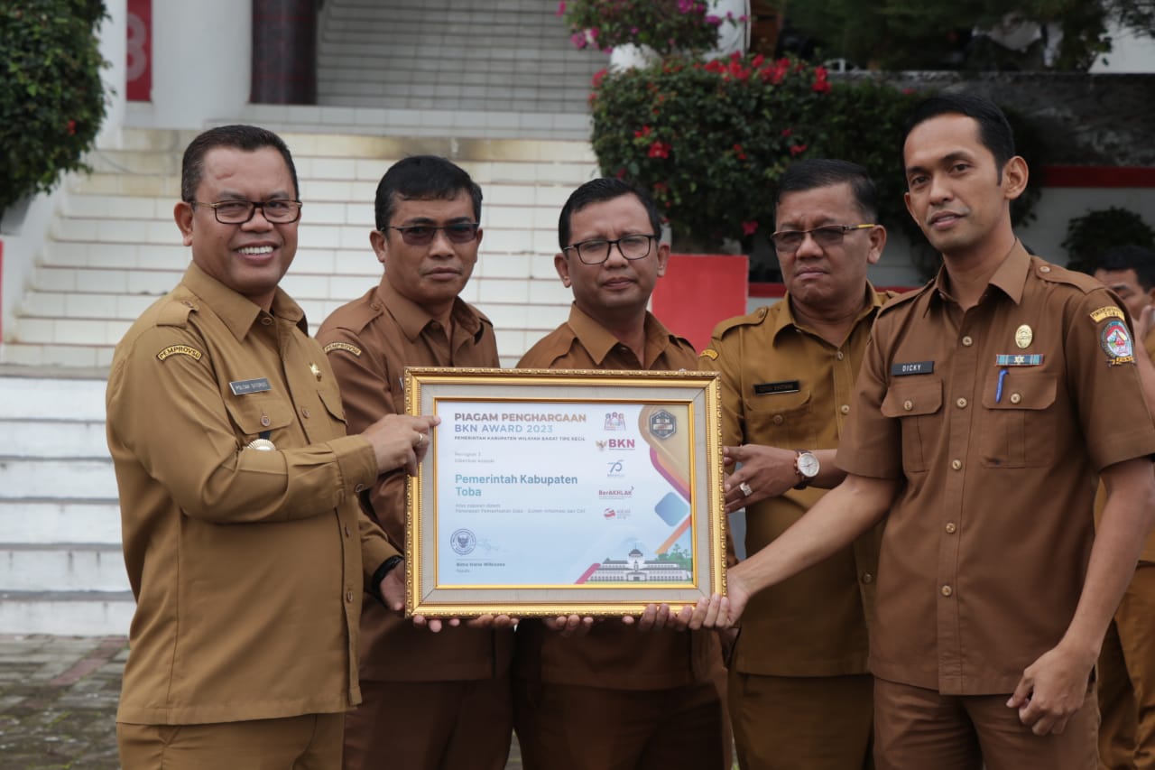 Keterangan foto: Bupati Toba, Poltak Sitorus bersama Sekda, Augus Sitorus dan beberapa pimpinan SKPD foto bersama piagam penghargaan juara III Wilayah Kerja Kanreg VI Medan untuk Kategori Penerapan Manajemen Kinerja dari Kepala BKN RI. (Ist).