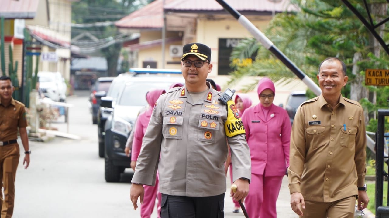 Teks Foto  Sekda Langkat, Amril, S.Sos., M.AP., mendampingi Kapolres Langkat, AKBP David Triyo Prasojo, S.H., S.I.K., M.Si., dalam kegiatan pembagian makan siang bergizi gratis di SLB Negeri Stabat, Senin (20/1/2025).Beritasore/ist. 