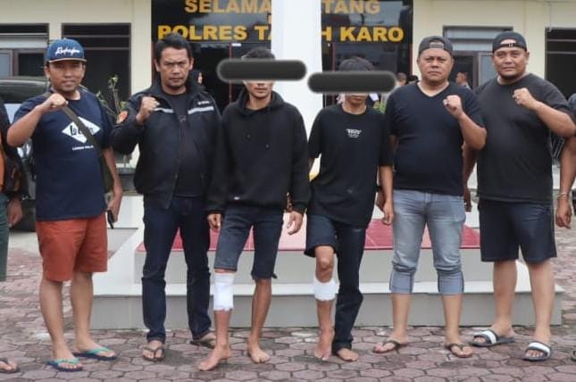 Petugas Satreskrim diabadikan saat mengapit para pelaku pembunuhan di halaman Mapolres Karo. (ist). 