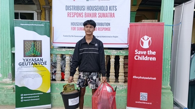 Teks foto : Salah satu warga saat menerima bantuan alat dapur dari Yayasan Geutanyoe dan Save The Children.